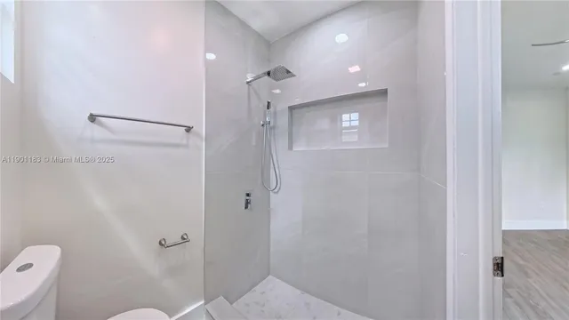 a bathroom with a shower and a toilet