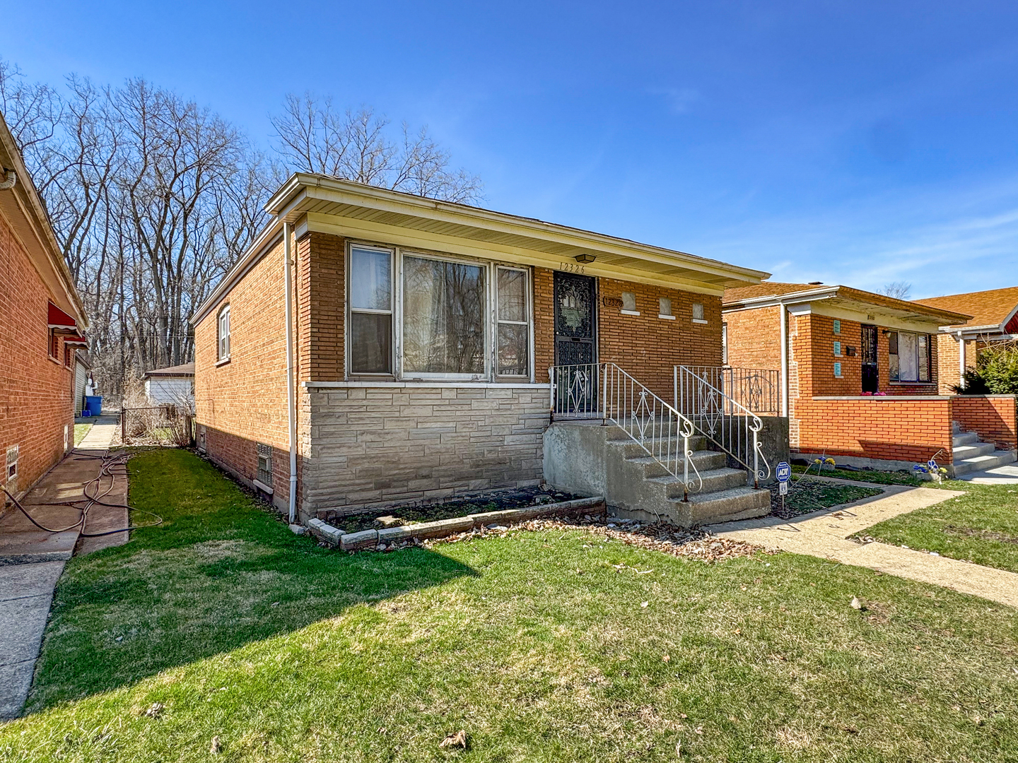 12326 South Indiana Avenue Chicago, IL 60628 - Photo 1 of 14 a view of a house with a yard