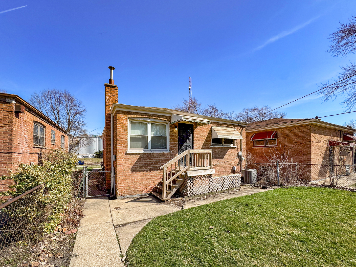 12326 South Indiana Avenue Chicago, IL 60628 - Photo 13 of 14 a front view of a house with patio
