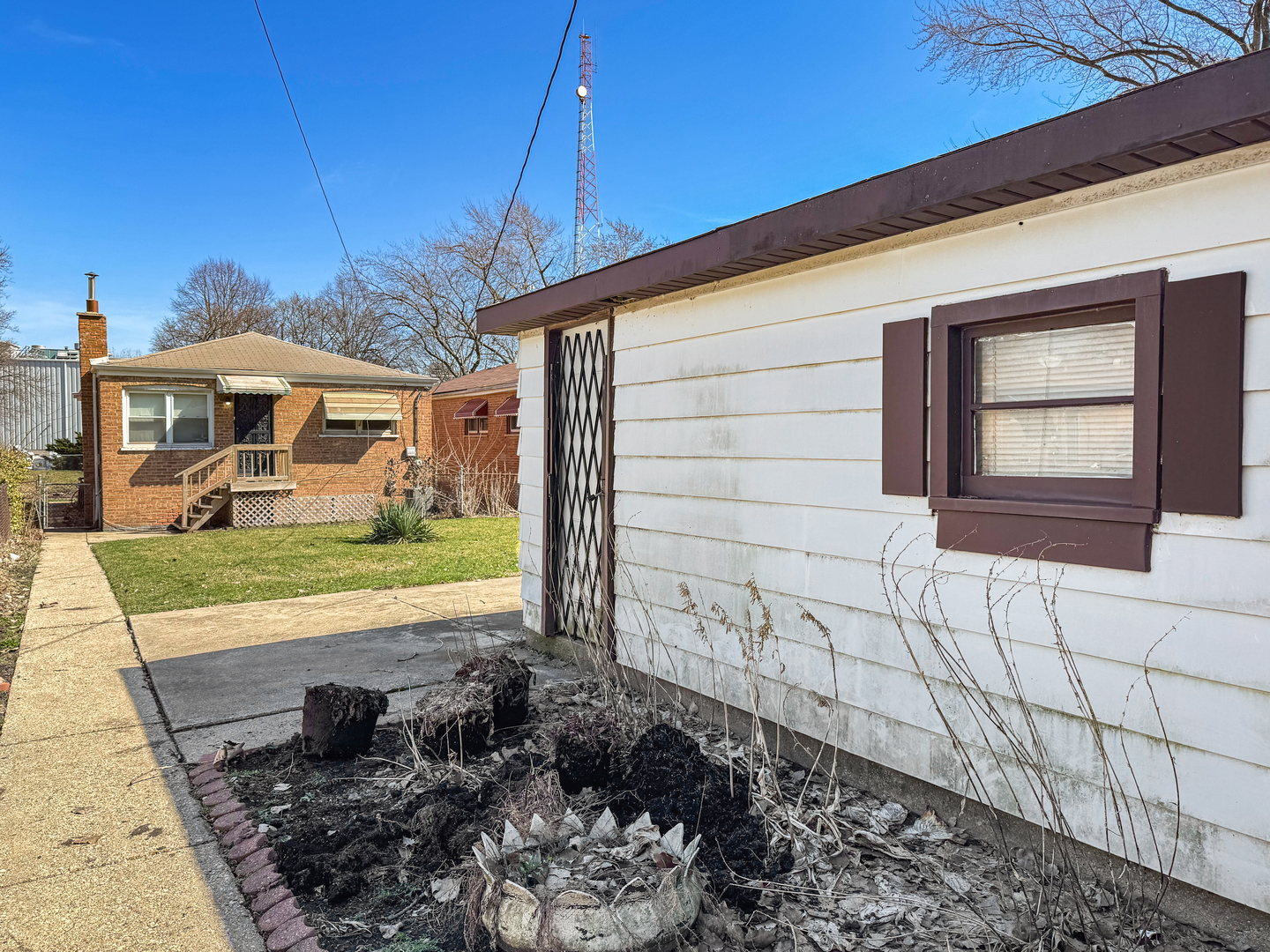 12326 South Indiana Avenue Chicago, IL 60628 - Photo 14 of 14 a front view of a house with garden