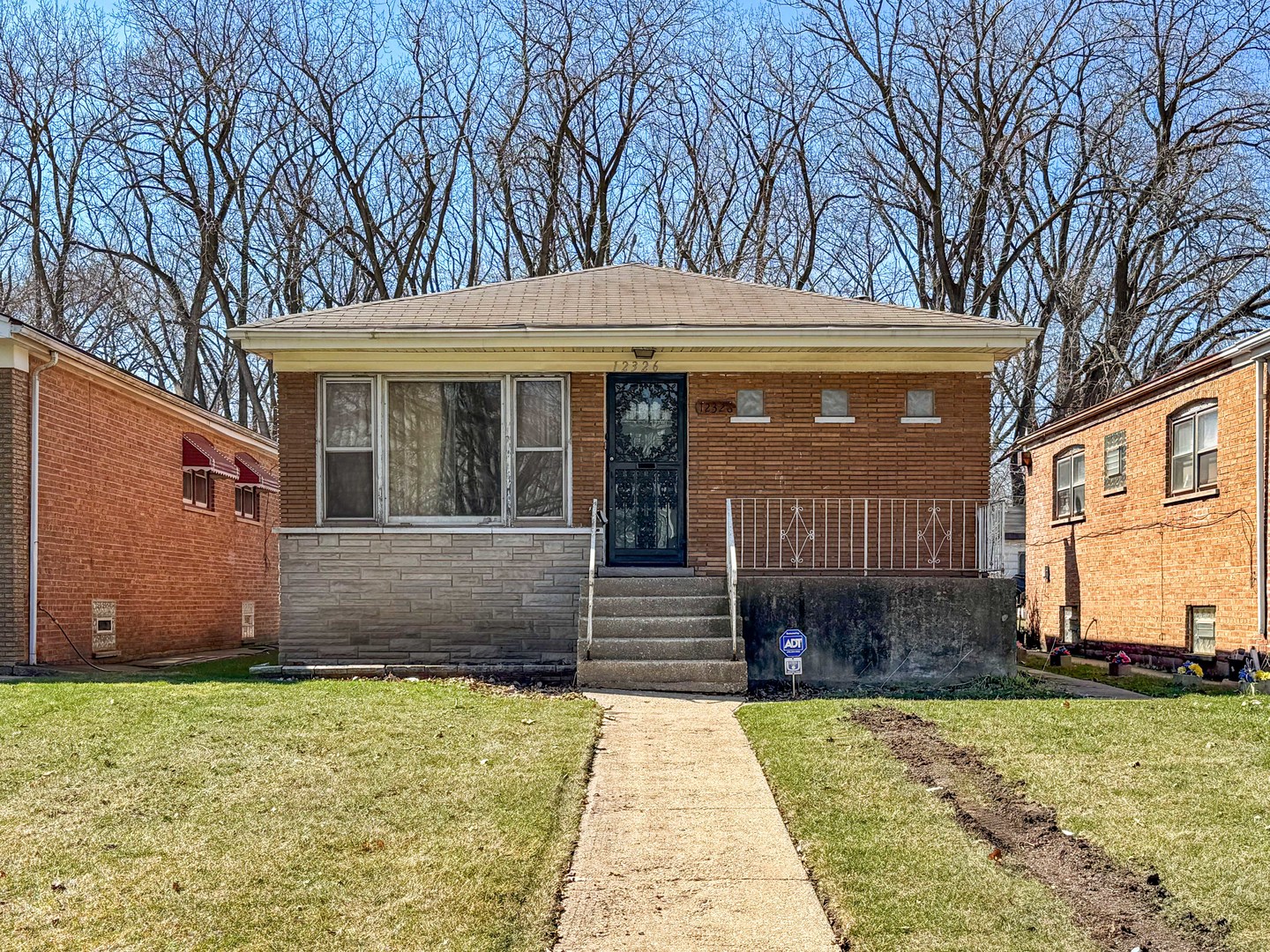 12326 South Indiana Avenue Chicago, IL 60628 - Photo 2 of 14 a front view of a house with garden