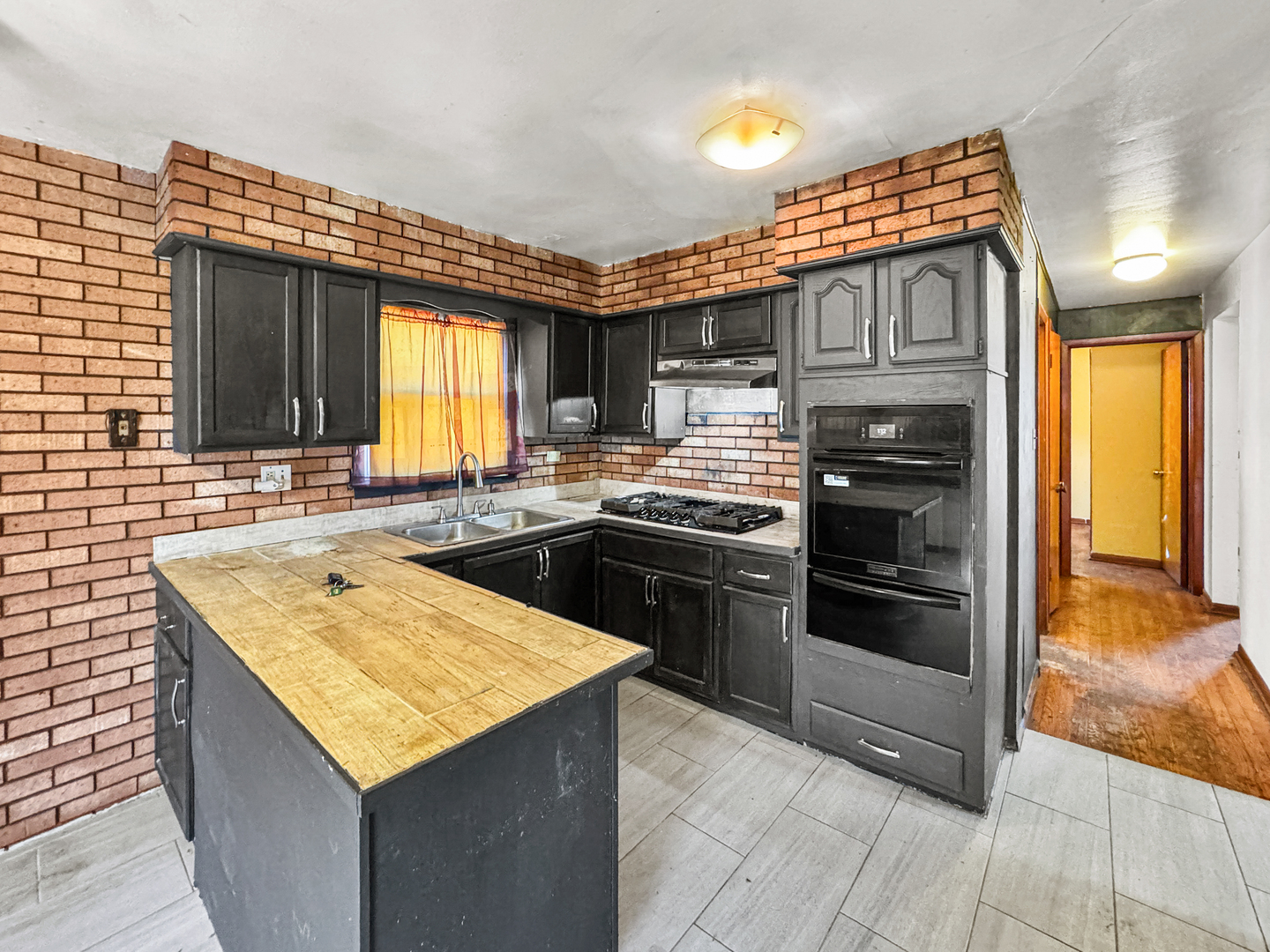 12326 South Indiana Avenue Chicago, IL 60628 - Photo 3 of 14 a kitchen with stainless steel appliances granite countertop a sink stove and refrigerator