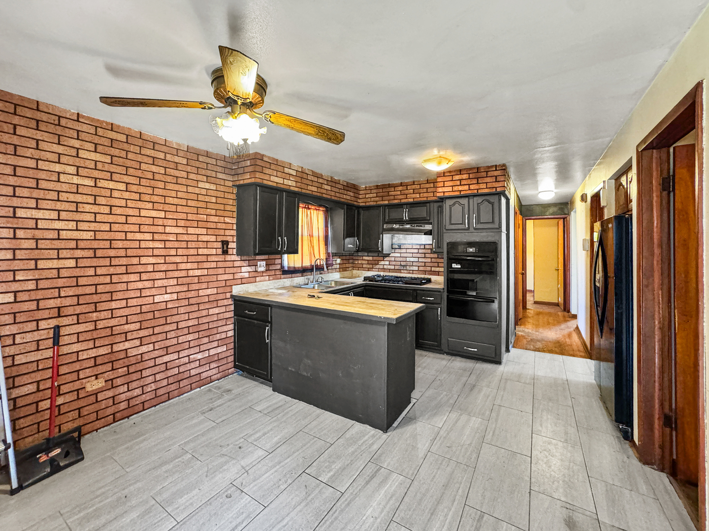12326 South Indiana Avenue Chicago, IL 60628 - Photo 4 of 14 a large kitchen with stainless steel appliances granite countertop a stove a sink dishwasher and a refrigerator