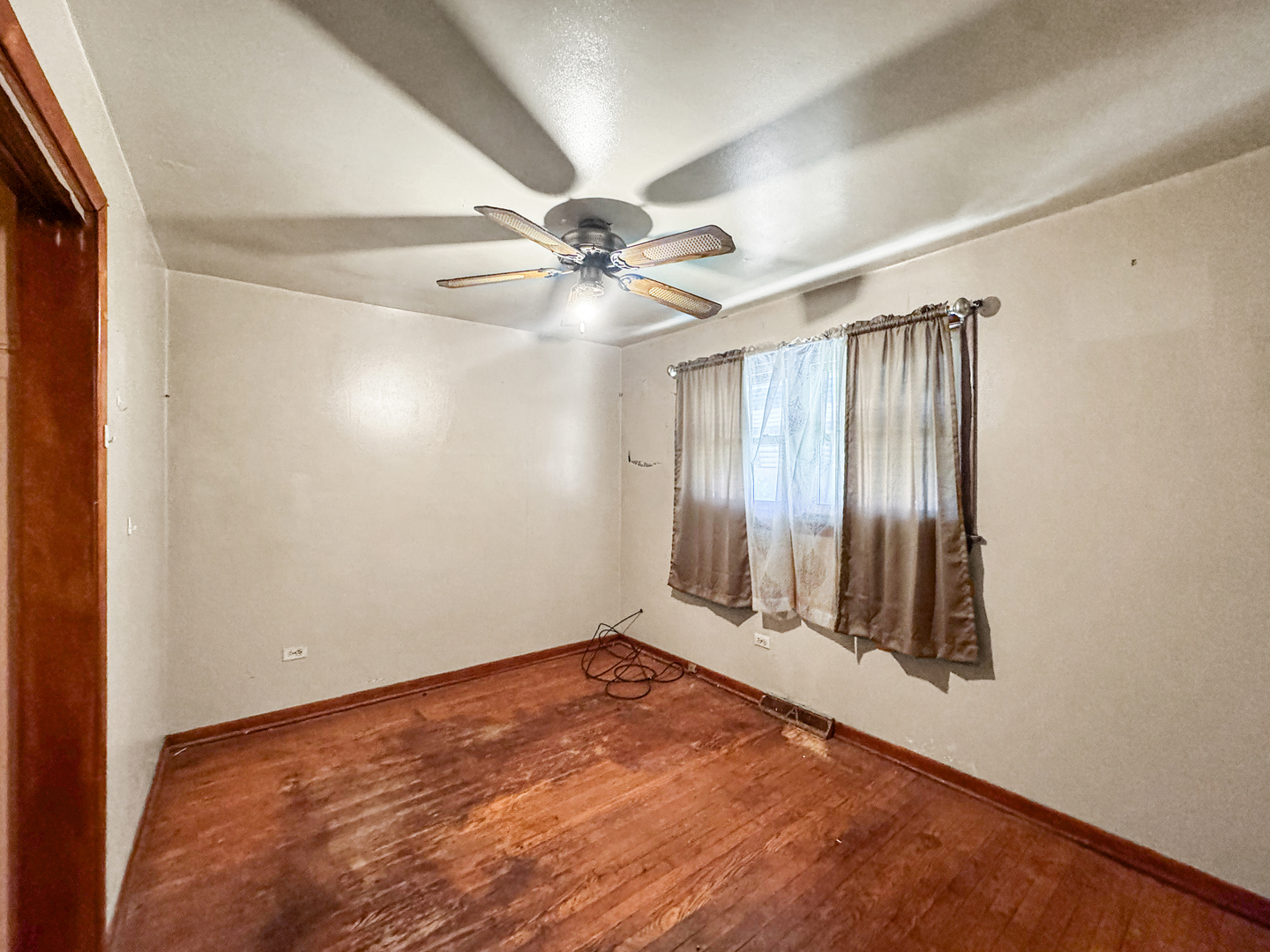12326 South Indiana Avenue Chicago, IL 60628 - Photo 8 of 14 an empty room with windows and fan