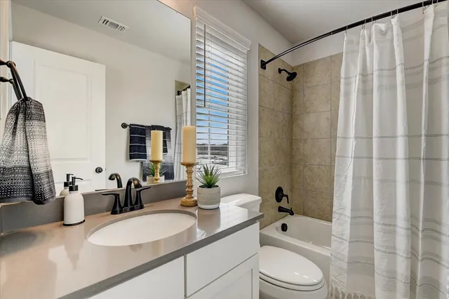a living room with furniture and a ceiling fan