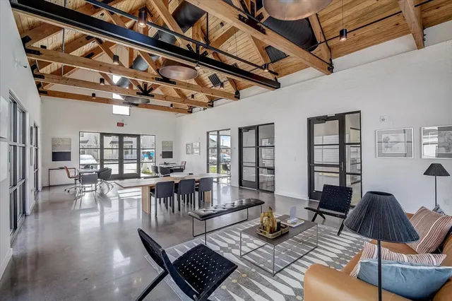 a living room with furniture a rug and a flat screen tv