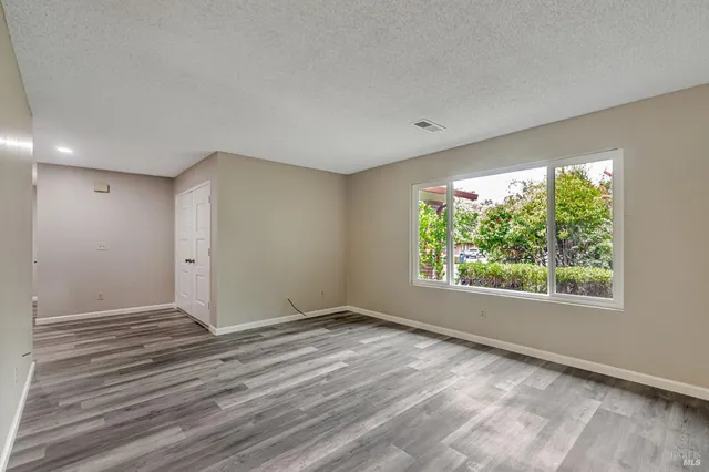 a kitchen with a sink a stove a refrigerator and white cabinets