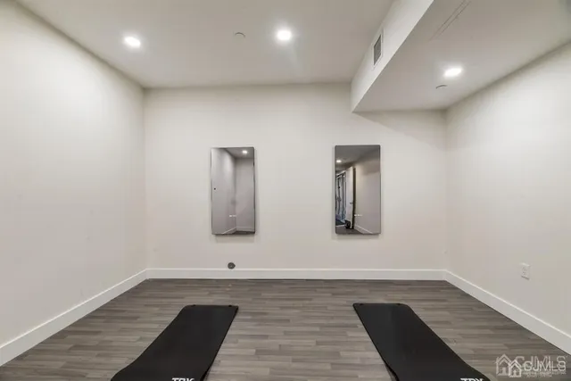 a view of a room with wooden floor and furniture