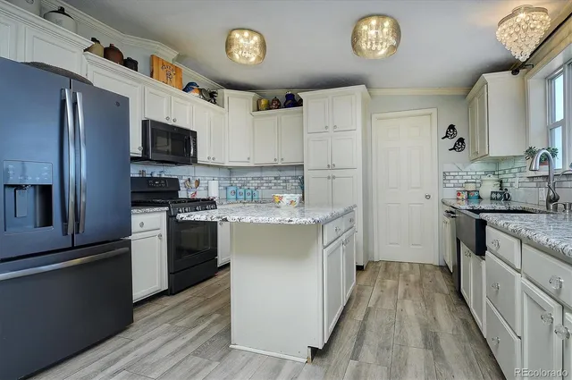 a kitchen with a refrigerator and a stove top oven