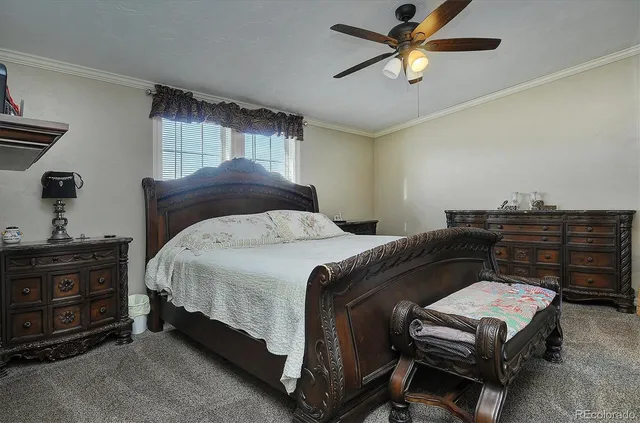 a bedroom with a bed and dresser with mirror