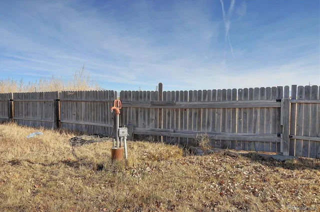 a view of a garage with storage and utility room