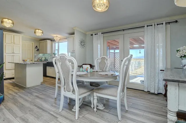 a dining room with furniture and wooden floor