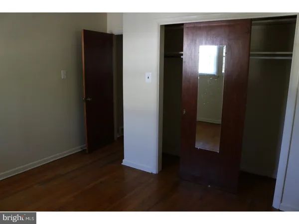 a view of hallway with wooden floor