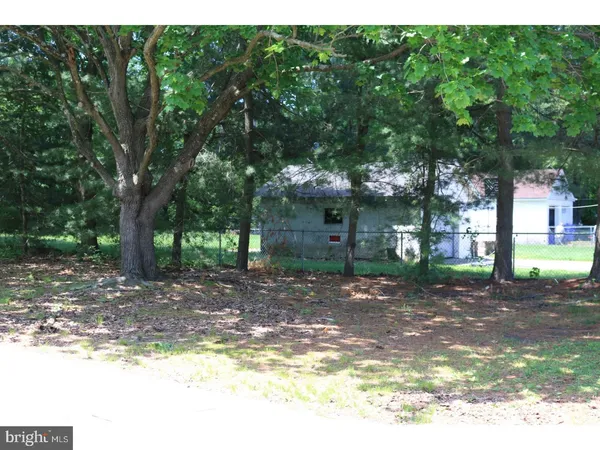 a view of a house with a tree in the background