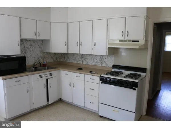 a kitchen with stainless steel appliances granite countertop white cabinets stove a sink and dishwasher
