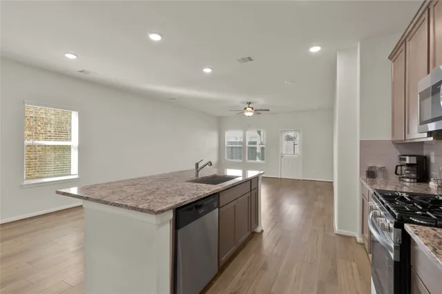 a kitchen with a sink stove and cabinets