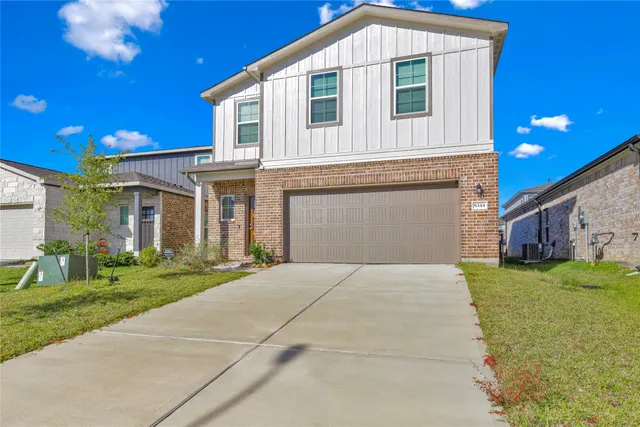 a front view of a house with a garden and yard