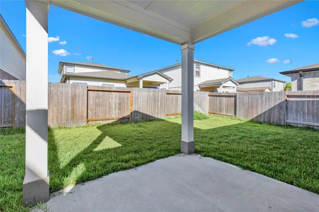 a view of a house with backyard and a garden