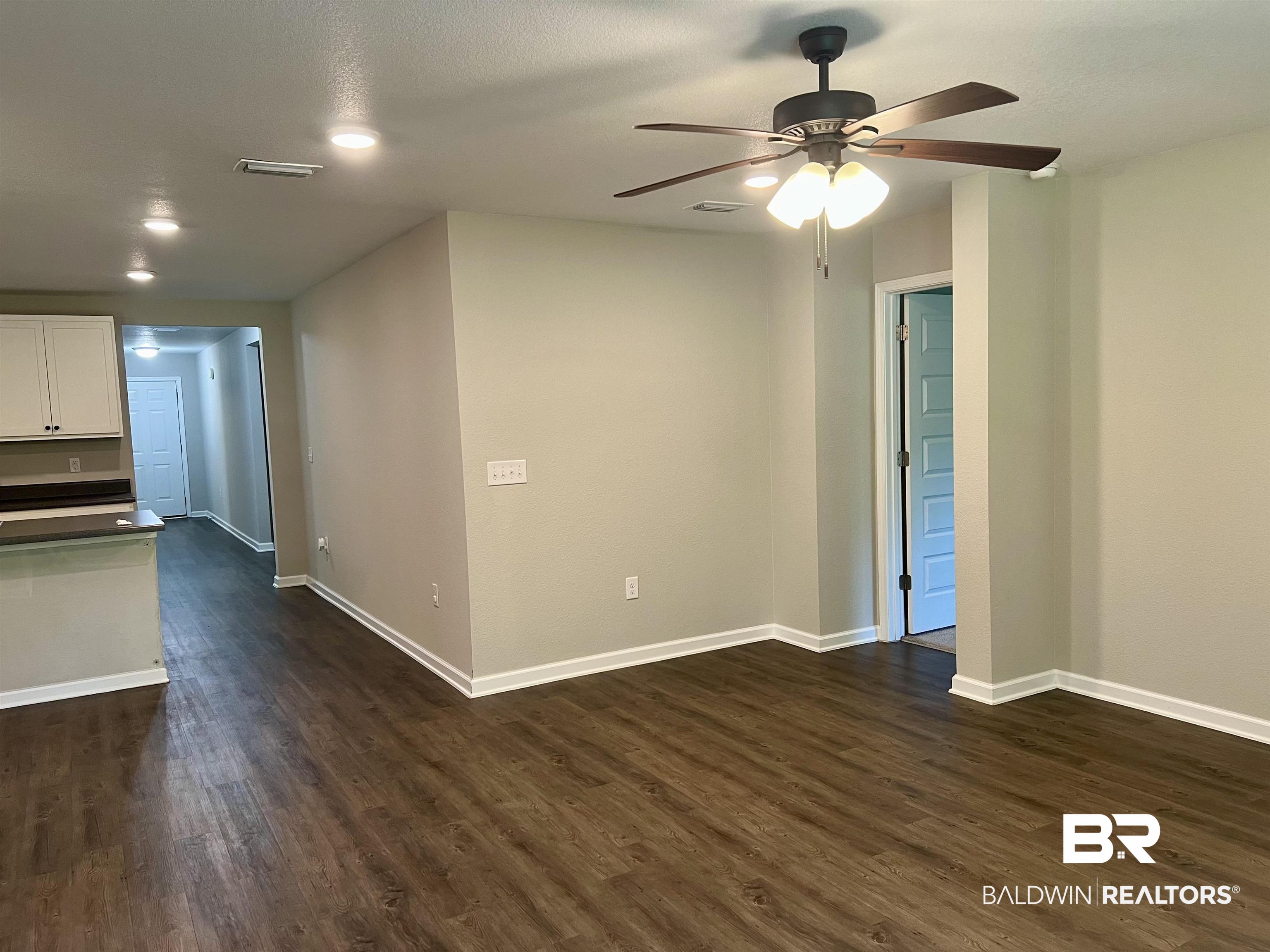 1612 Abbey Loop Foley, AL 36535 - Photo 15 of 30 Spare room featuring ceiling fan and dark wood-type flooring