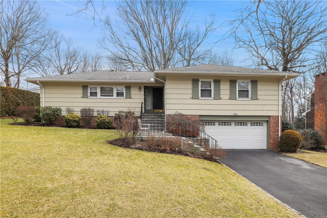 7 Eagles Bluff Rye Brook, NY 10573 - Photo 1 of 1 a front view of a house with yard and trees