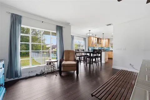 a view of a dining room with furniture and wooden floor