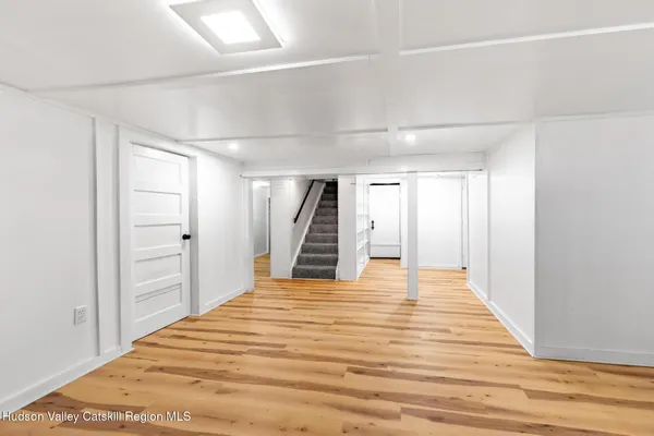 a view of a room with wooden floor and stairs