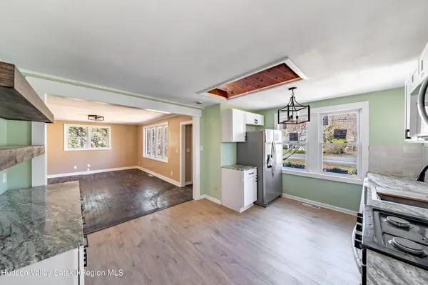 a view of a kitchen with furniture and wooden floor