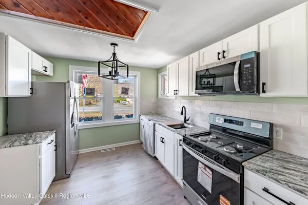 a kitchen with stainless steel appliances granite countertop a stove and a sink