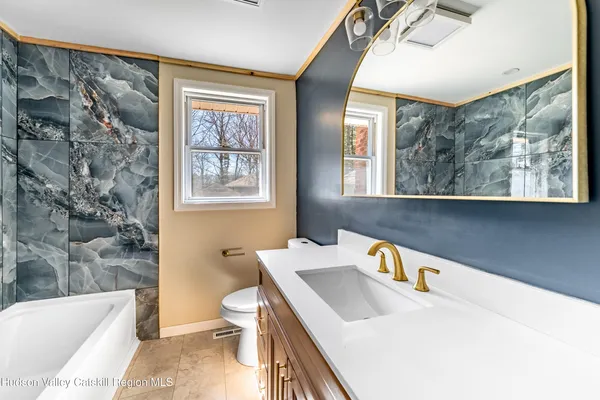 a bathroom with a sink a toilet and a bathtub