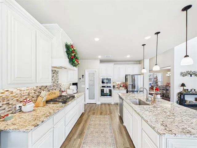 a large kitchen with kitchen island lots of counter space