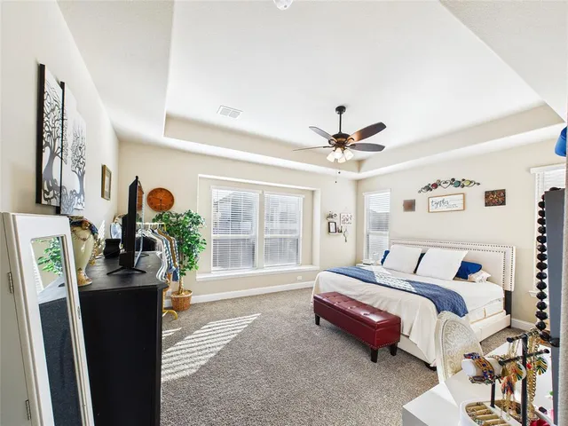 a bedroom with furniture and a large window