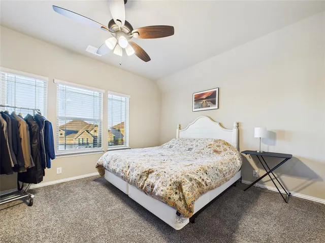 a bedroom with a bed closet and a window