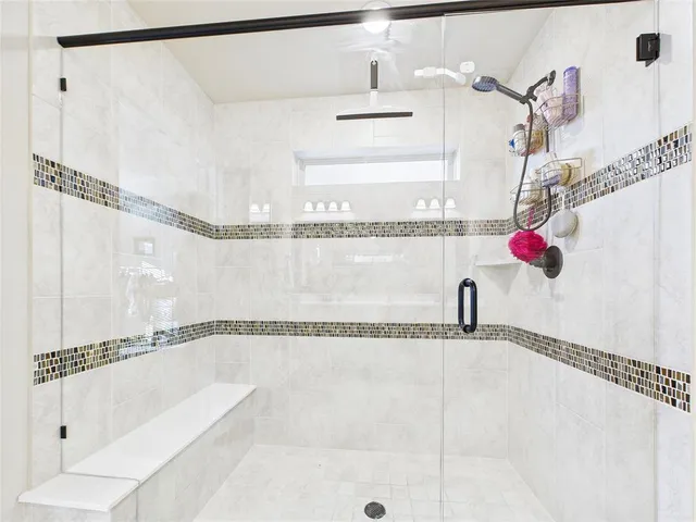 a bathroom with a shower and a bath tub