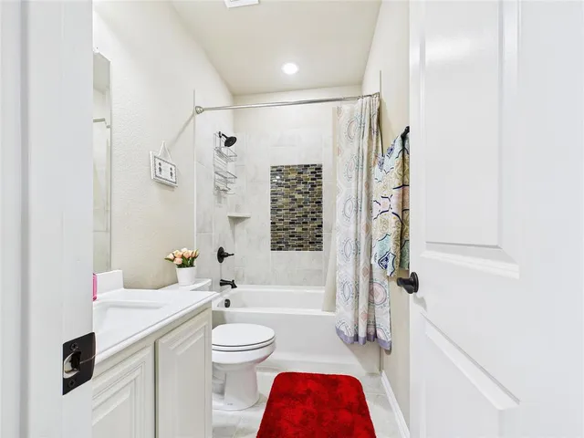 a bathroom with a toilet a sink and a bathtub