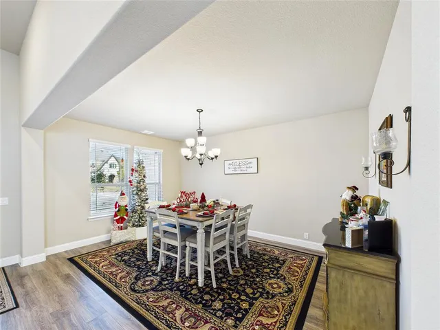 a view of a dining room with furniture and chandelier