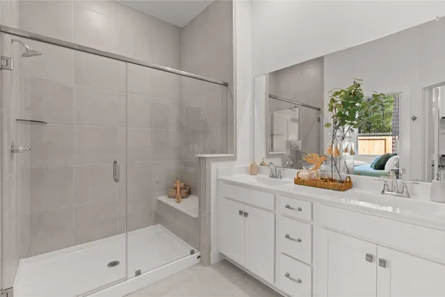 a bathroom with a shower sink and mirror
