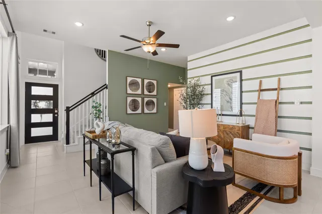 a living room with furniture and wooden floor