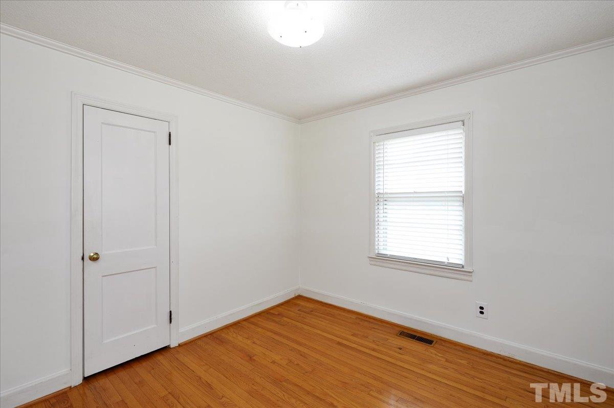 755 Wait Avenue Wake Forest, NC 27587 - Photo 13 of 23 an empty room with wooden floor and window