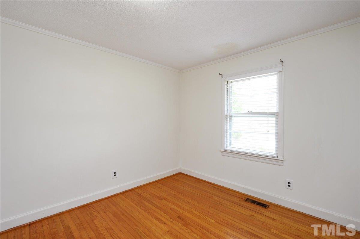 755 Wait Avenue Wake Forest, NC 27587 - Photo 14 of 23 an empty room with wooden floor and windows
