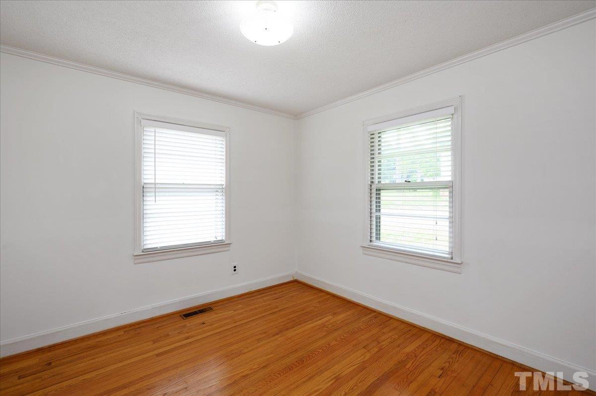 755 Wait Avenue Wake Forest, NC 27587 - Photo 17 of 23 an empty room with wooden floor and windows