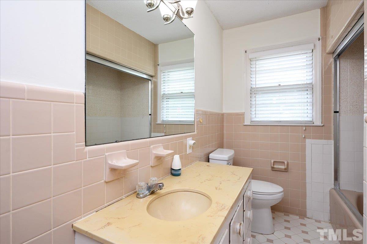 755 Wait Avenue Wake Forest, NC 27587 - Photo 18 of 23 a bathroom with a sink toilet vanity and mirror