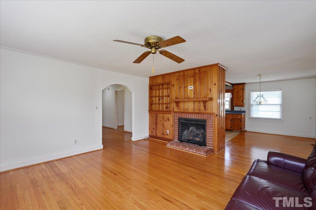 755 Wait Avenue Wake Forest, NC 27587 - Photo 4 of 23 a view of a livingroom with furniture wooden floor fireplace and a window