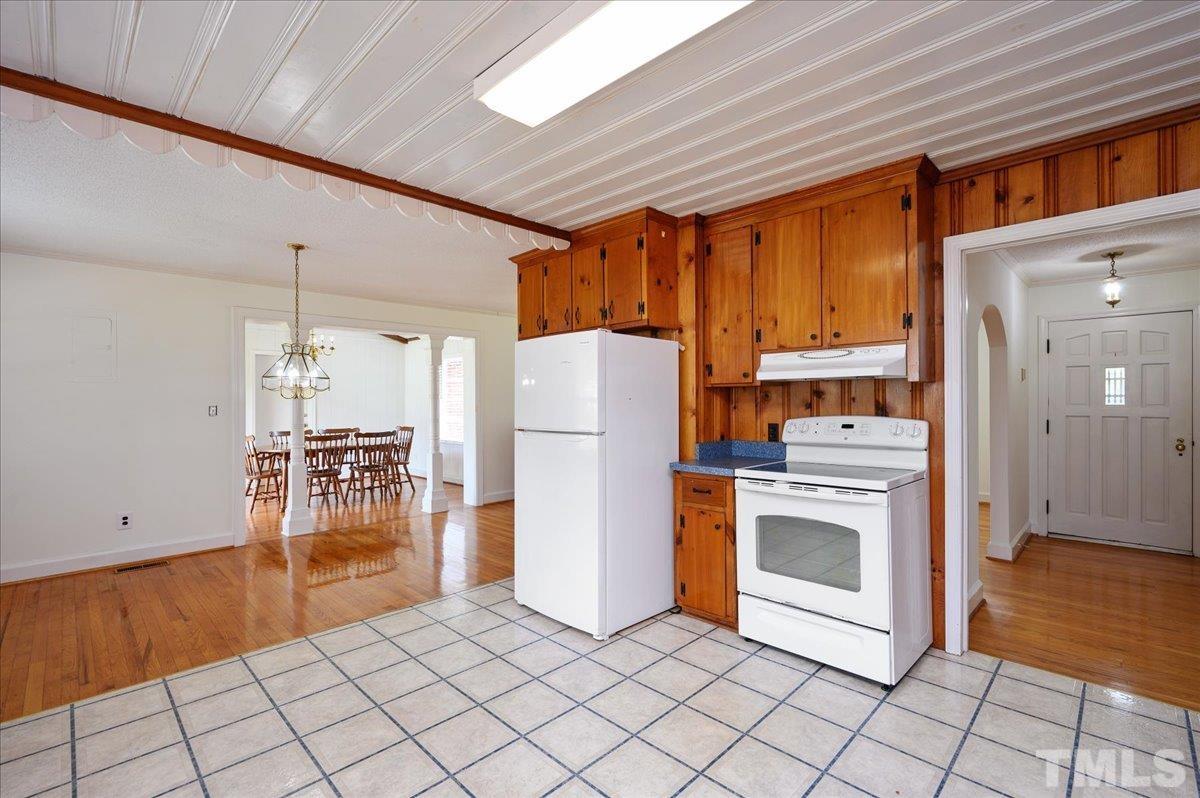 755 Wait Avenue Wake Forest, NC 27587 - Photo 8 of 23 a kitchen with a stove a refrigerator and cabinets