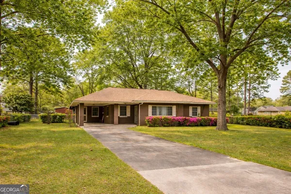 a front view of house with yard and green space