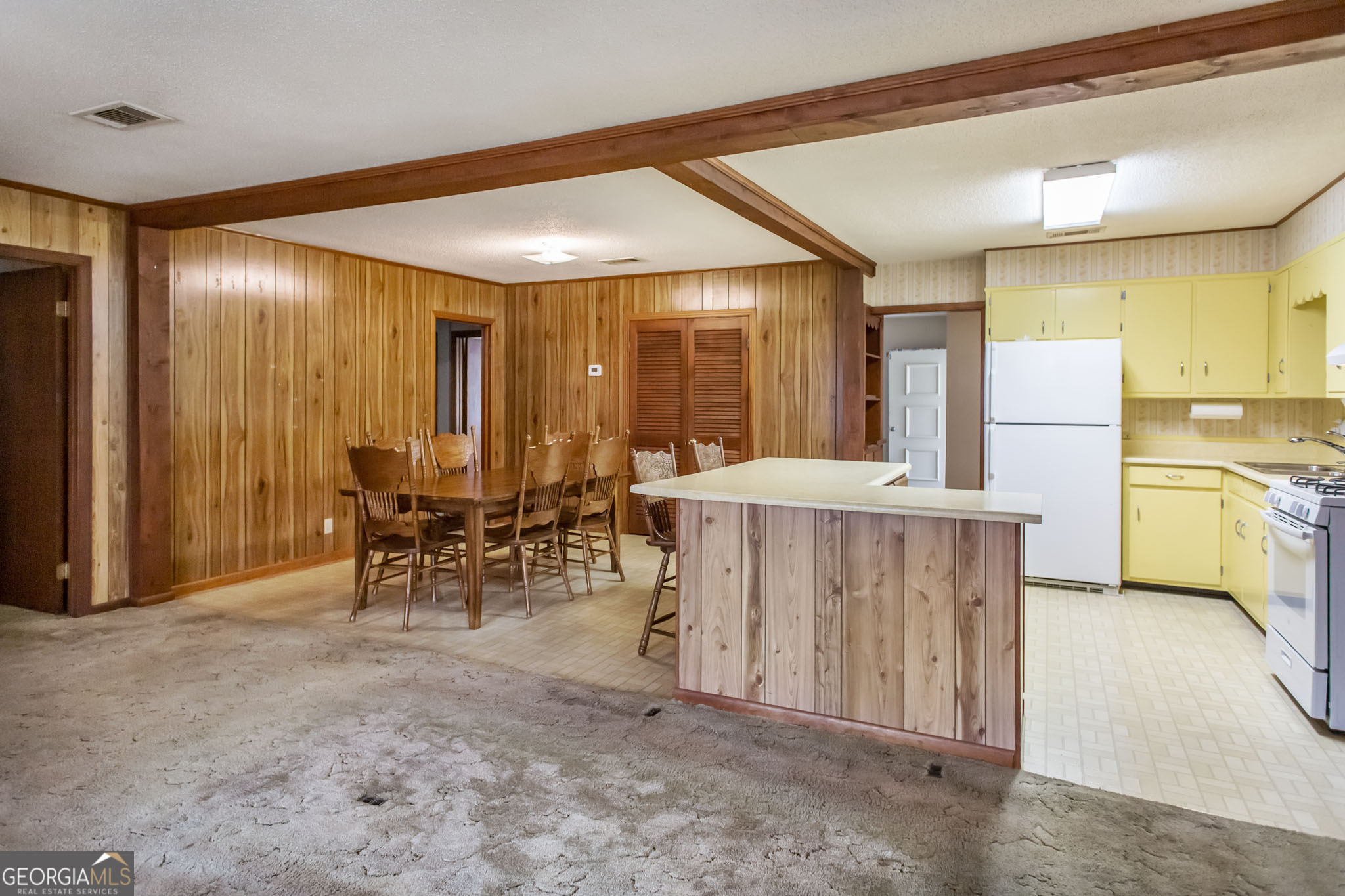 1917 Gilchrist Avenue Waycross, GA 31503 - Photo 17 of 42 a dining hall with stainless steel appliances a dining table and chairs