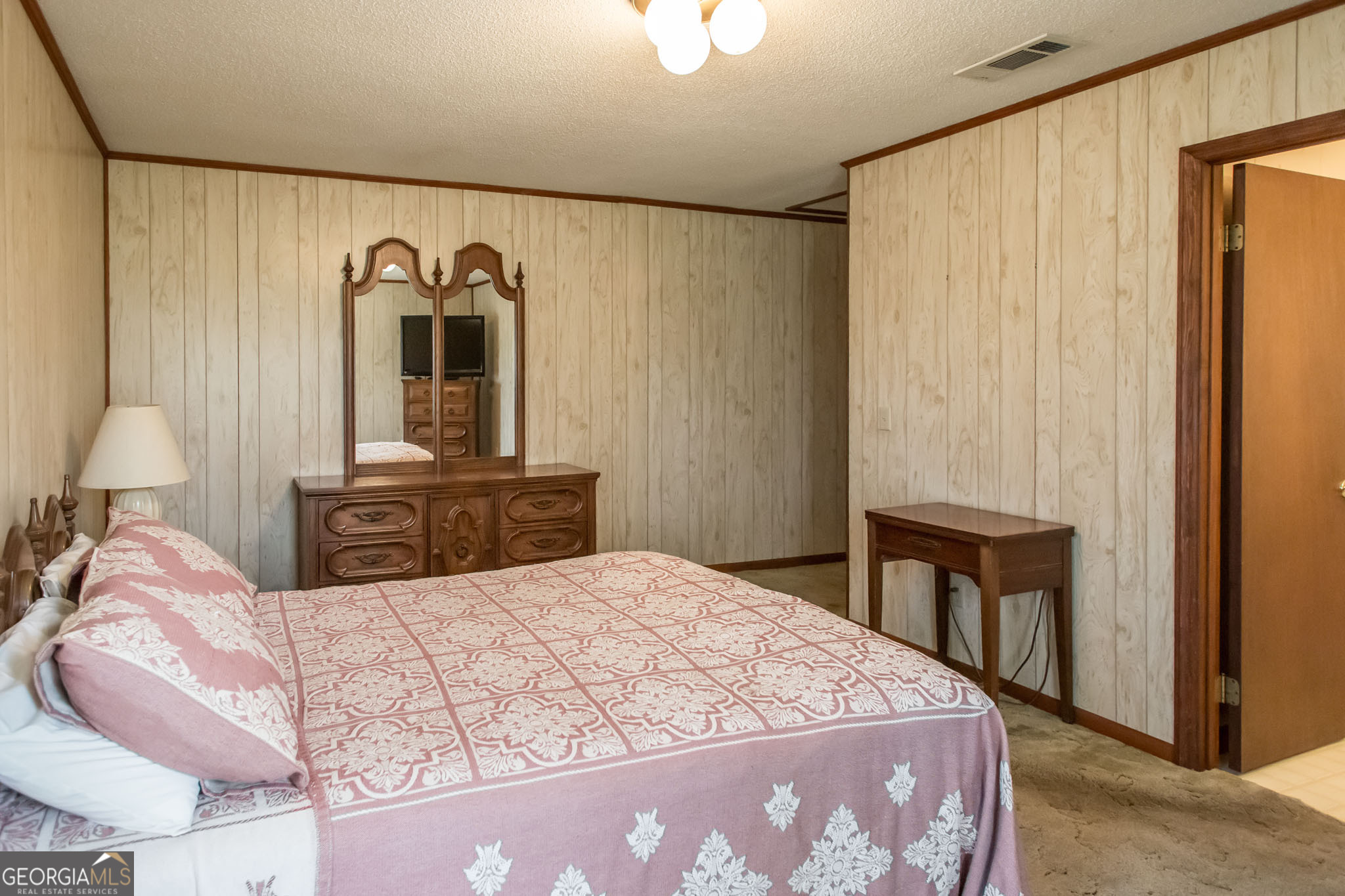 1917 Gilchrist Avenue Waycross, GA 31503 - Photo 20 of 42 a bedroom with a bed and a table in it