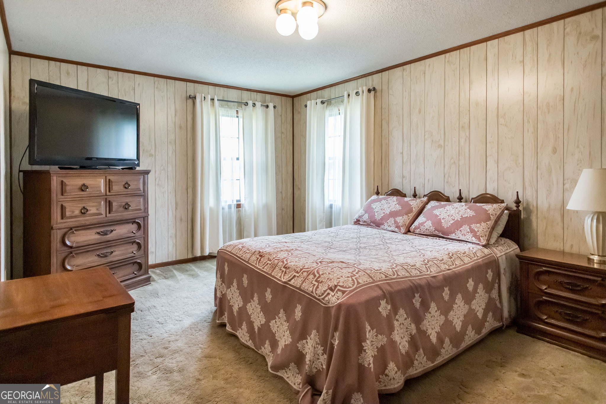 1917 Gilchrist Avenue Waycross, GA 31503 - Photo 21 of 42 a bedroom with a bed and a flat screen tv