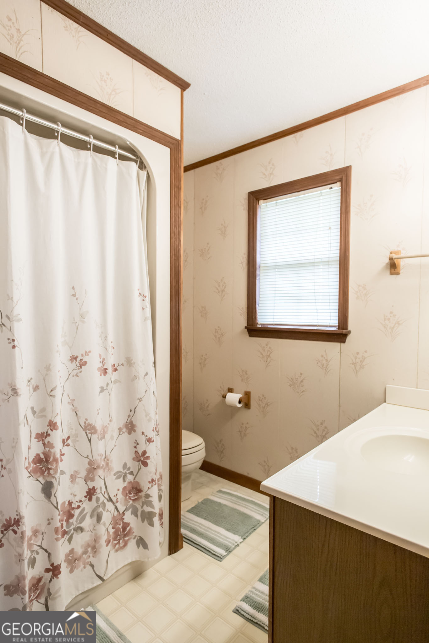 1917 Gilchrist Avenue Waycross, GA 31503 - Photo 23 of 42 a bathroom with a granite countertop sink a mirror and shower
