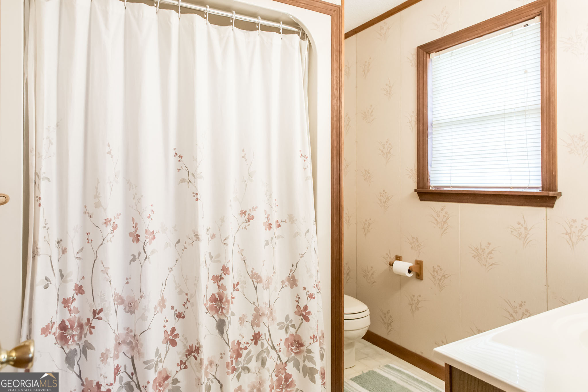 1917 Gilchrist Avenue Waycross, GA 31503 - Photo 26 of 42 a bathroom with a shower curtain and a window