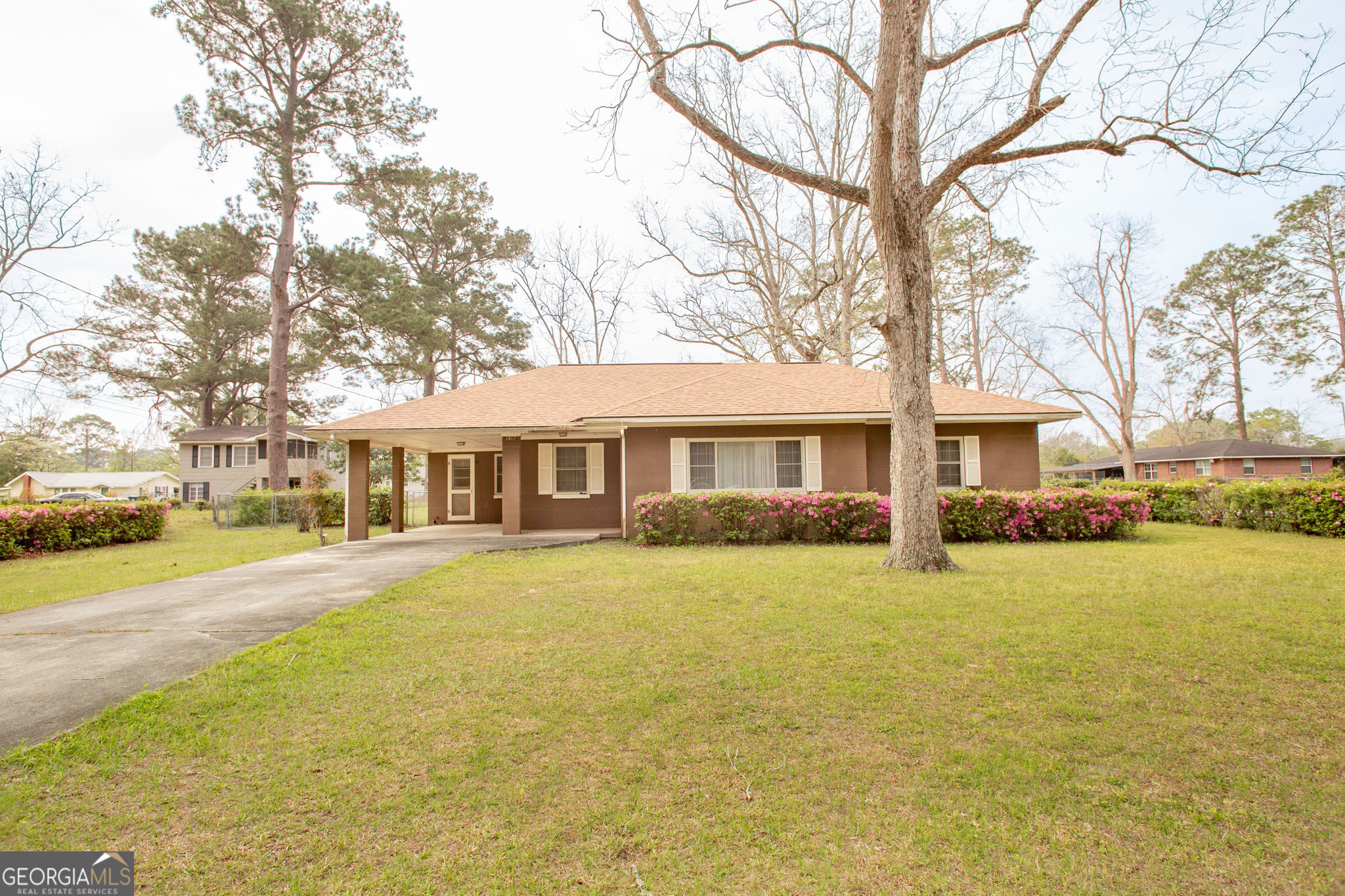 1917 Gilchrist Avenue Waycross, GA 31503 - Photo 3 of 42 a front view of a house with a garden and trees